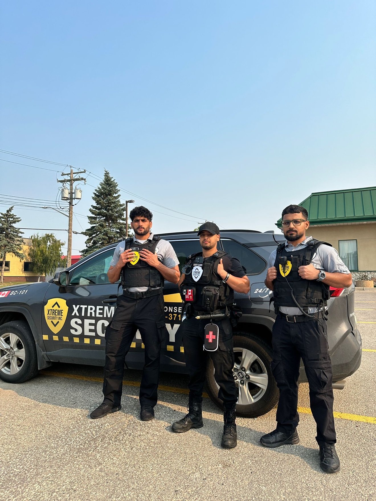 Three Xtreme Security guards with marked patrol SUV in BC
